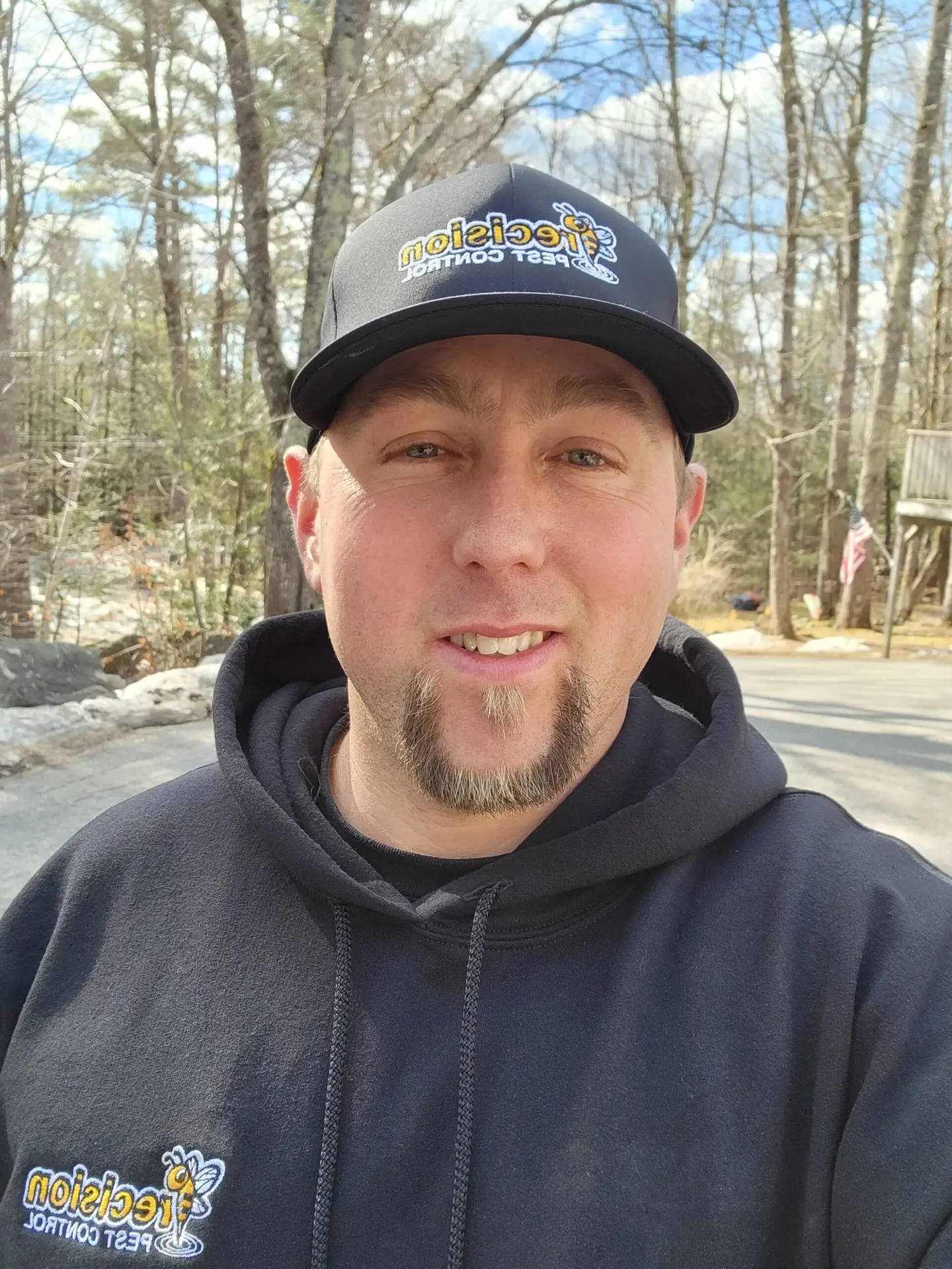 About Precision Pest Control in Southern Maine - owner in branded hat and hoodie outdoors