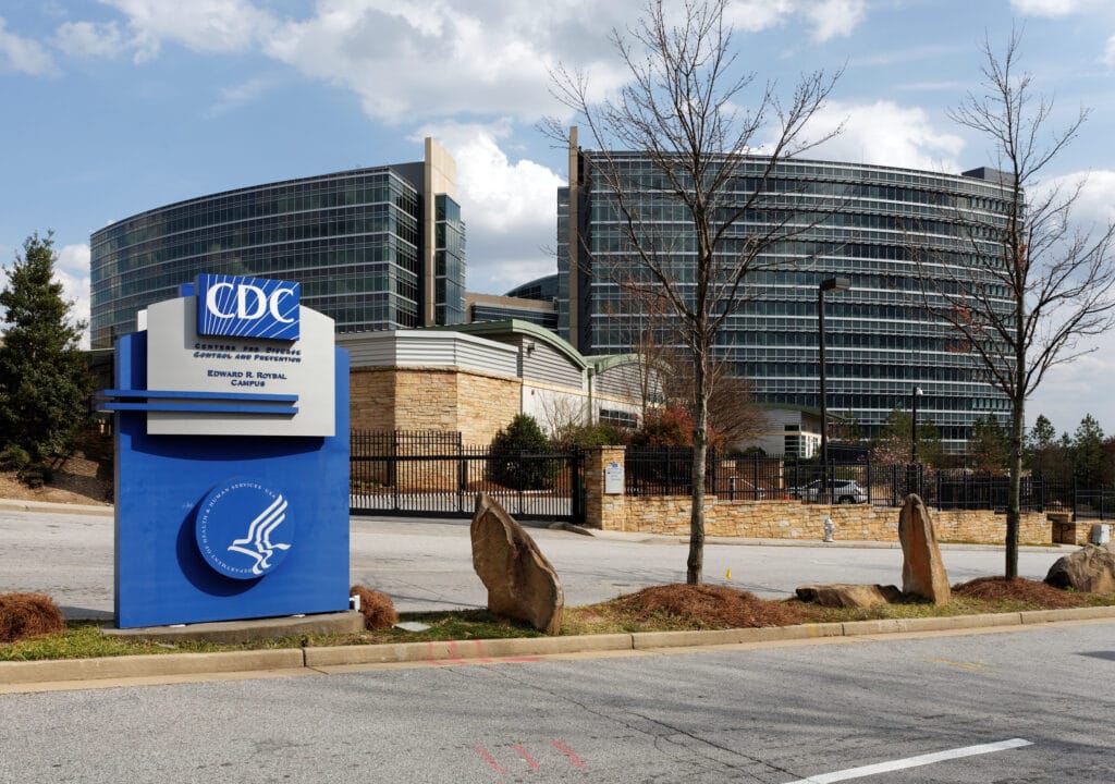 The CDC headquarters sign and glass office buildings at the Edward R. Roybal Campus in Atlanta, Georgia